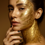 Woman with gold face decoration and Brown Nails